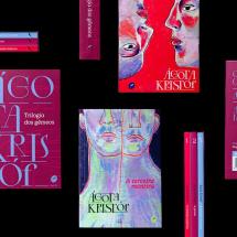 Imagem com fundo preto exibe diversas capas e lombadas da trilogia "O Grande Caderno", "A Prova" e "A Terceira Mentira", da escritora Ágota Kristóf. As capas, com design gráfico marcante e tons vibrantes de vermelho, rosa, azul e roxo, mostram rostos e figuras duplicadas, remetendo à temática dos gêmeos presente na obra. O nome da autora aparece em destaque, com tipografia moderna e artística.