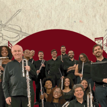 A imagem mostra os integrantes da Orquestra Carioca de Flauta posando sorridentes com seus instrumentos, como flautas e flautas-baixas. Eles vestem roupas pretas e estão organizados em duas fileiras diante de um fundo ilustrado com desenhos de instrumentos de orquestra e um grande círculo vermelho central. A composição transmite harmonia, talento coletivo e celebração da música.